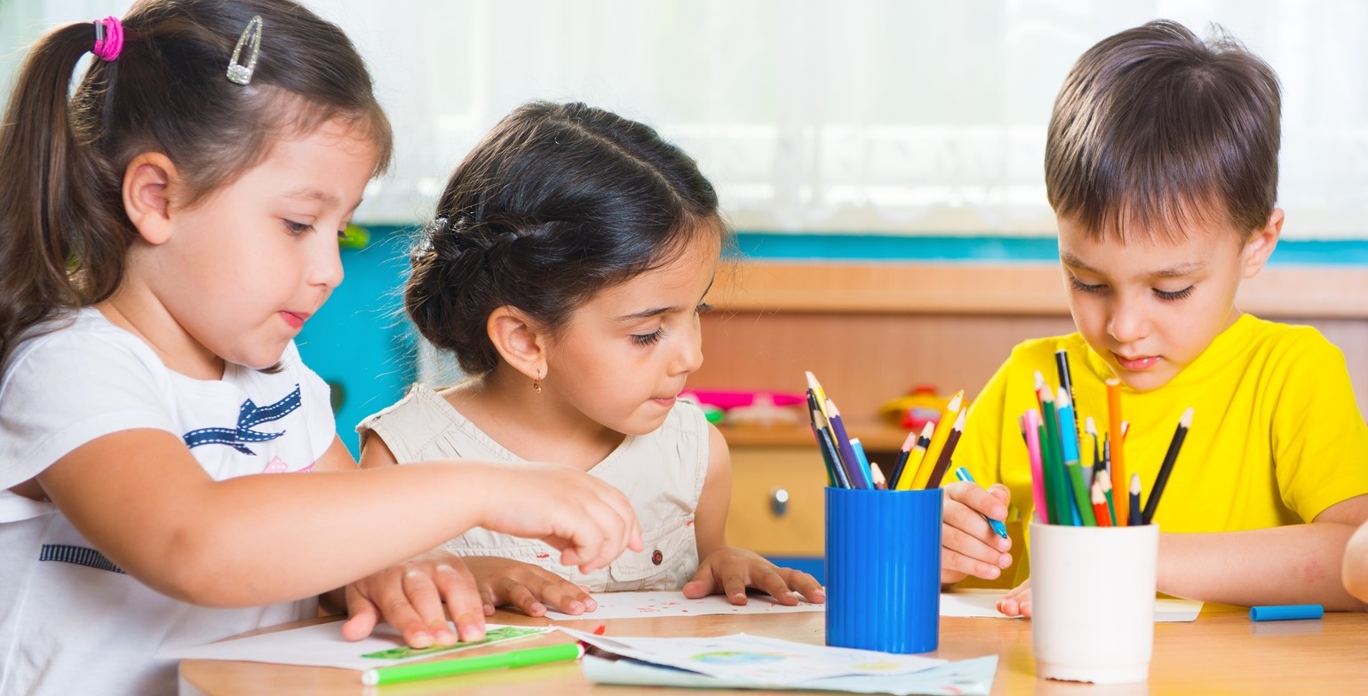 Group of cute little prescool kids drawing with colorful pencils ...